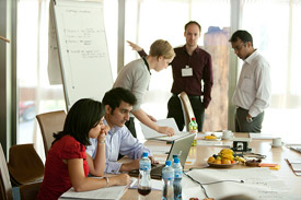 People presenting around a conference table