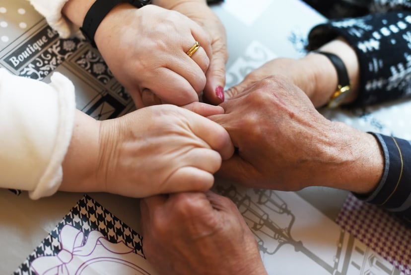 Photo of seniors holding hands