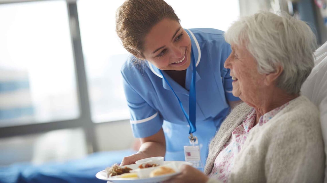 Nurse cares for resident at an assisted living community