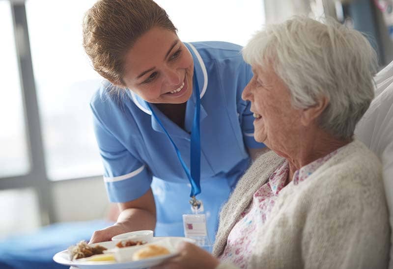Nurse serving assisted living resident