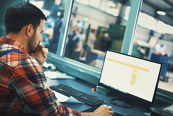 Photo of a man using a computer to find a tank part number