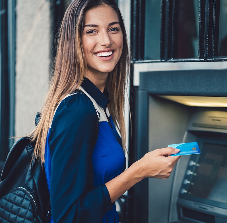 Photo of a young woman with an ATM card