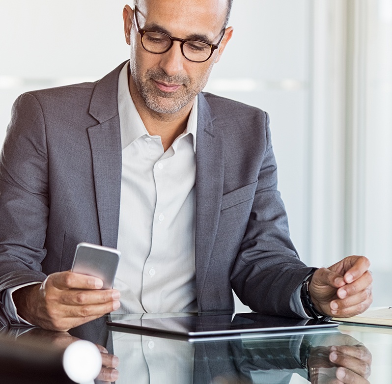 Photo of a businessman searching on his mobile device