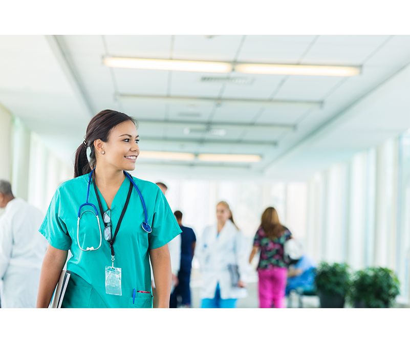 Photo of a healthcare professional walking down a hallway